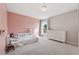 Charming bedroom features carpeted floors, a soft pink wall, natural light and a fun, creative atmosphere at 1820 Primrose Park Rd, Sugar Hill, GA 30518