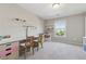 Bright bedroom featuring carpeted floors, neutral walls, work space and a window with a view of outdoors at 1820 Primrose Park Rd, Sugar Hill, GA 30518