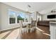 Sunny dining area with hardwood floors and views of the backyard at 1820 Primrose Park Rd, Sugar Hill, GA 30518