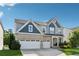 Charming home featuring a brick facade, multi-car garage and a neatly maintained yard at 1820 Primrose Park Rd, Sugar Hill, GA 30518