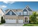 Beautiful two-story home with a two-car garage and a well-manicured lawn at 1820 Primrose Park Rd, Sugar Hill, GA 30518