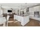 Kitchen opens to the living room and boasts a large center island, stainless steel appliances, and modern fixtures at 1820 Primrose Park Rd, Sugar Hill, GA 30518