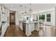Spacious kitchen featuring a large island, granite countertops, stainless appliances and dining area at 1820 Primrose Park Rd, Sugar Hill, GA 30518