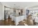 Bright kitchen features stainless steel appliances, a large center island with granite countertops and pendant lighting at 1820 Primrose Park Rd, Sugar Hill, GA 30518