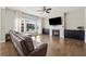 Cozy living room with a fireplace, hardwood floors and a large window at 1820 Primrose Park Rd, Sugar Hill, GA 30518