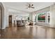 Open-concept living room showcasing hardwood floors, large windows, and comfortable seating at 1820 Primrose Park Rd, Sugar Hill, GA 30518
