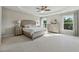 Spacious bedroom features a tray ceiling, plush carpeting, and abundant natural light from the large windows at 1820 Primrose Park Rd, Sugar Hill, GA 30518