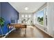 Bright office space with large windows, wood floors, and a stylish accent wall for a productive workspace at 1820 Primrose Park Rd, Sugar Hill, GA 30518