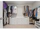 Spacious walk-in closet with custom shelving, hanging racks, and ample storage for clothing and accessories at 1820 Primrose Park Rd, Sugar Hill, GA 30518