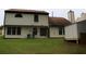 Backyard view featuring ample green space and the back exterior of the home at 3255 Hunters Crossing Pt, Lithonia, GA 30038