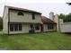 View of the home's back exterior and a green lawn at 3255 Hunters Crossing Pt, Lithonia, GA 30038