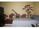 Bedroom with a nature scene painted on the wall with neutral paint at 3255 Hunters Crossing Pt, Lithonia, GA 30038