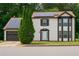 Inviting two-story home featuring solar panels, brown trim, a well-manicured lawn, and an attached garage at 3255 Hunters Crossing Pt, Lithonia, GA 30038