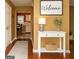 Welcoming foyer shows warm accents, hardwood floors, and an open view to the kitchen at 3255 Hunters Crossing Pt, Lithonia, GA 30038