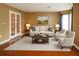 Bright and airy living room featuring hardwood floors, a plush rug, and elegant furnishings at 3255 Hunters Crossing Pt, Lithonia, GA 30038