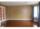 Sunlit living room has hardwood floors and white french doors at 3255 Hunters Crossing Pt, Lithonia, GA 30038