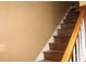 Carpeted staircase with wooden handrail and white trim, connecting the home's levels at 3255 Hunters Crossing Pt, Lithonia, GA 30038
