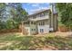 A home's backyard with a covered patio and a well-maintained lawn and landscaped perimeter at 3541 Wilton Ave, Atlanta, GA 30340
