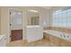 Bathroom features a jacuzzi tub and a large vanity with mirror and storage at 3541 Wilton Ave, Atlanta, GA 30340