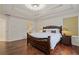 Bright bedroom boasts an ornate wood bed frame and a large bay window at 3541 Wilton Ave, Atlanta, GA 30340