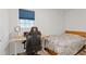 Well-lit bedroom with a cozy bed, window with blind, desk, and gaming chair setup at 3541 Wilton Ave, Atlanta, GA 30340