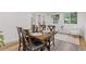 Dining room with wood table, chairs, natural light, and access to sunroom at 3541 Wilton Ave, Atlanta, GA 30340