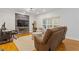 Cozy living room featuring a stone fireplace, hardwood floors, and comfortable seating, creating a warm atmosphere at 3541 Wilton Ave, Atlanta, GA 30340