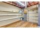 Basement storage area with open shelving and wood laminate flooring at 514 Macedonia Forest Circle Cir, Canton, GA 30115