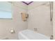 Bathroom featuring a white tub, tiled walls and a window for light at 514 Macedonia Forest Circle Cir, Canton, GA 30115
