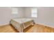 Bedroom with hardwood floors, two windows and a bed at 514 Macedonia Forest Circle Cir, Canton, GA 30115