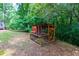 Backyard wooden chicken coop nestled amongst mature trees at 514 Macedonia Forest Circle Cir, Canton, GA 30115