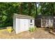 Outdoor shed with siding, and greenery, adding functionality and charm to the landscape at 514 Macedonia Forest Circle Cir, Canton, GA 30115