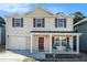 Inviting two-story home with a welcoming front porch, garage, and a well-maintained facade at 5987 Westchase St, Atlanta, GA 30336