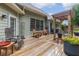 Spacious outdoor patio featuring chairs, wooden deck, grill and pergola, perfect for outdoor gatherings at 2905 Ivey Ridge Ln, Roswell, GA 30076