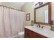 Well-lit bathroom featuring a vanity with a marble countertop, a large mirror, and a shower with a curtain at 2905 Ivey Ridge Ln, Roswell, GA 30076