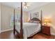 Comfortable bedroom featuring natural light, wood floors and a ceiling fan at 2905 Ivey Ridge Ln, Roswell, GA 30076