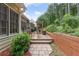 Private deck with mature landscaping, wooden retaining wall, stone walkway, and an outdoor seating area at 2905 Ivey Ridge Ln, Roswell, GA 30076