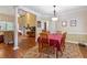 Formal dining area featuring hardwood floors, a decorative rug, and a six-chair dining set at 2905 Ivey Ridge Ln, Roswell, GA 30076