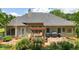 Rear exterior view showing a deck with a pergola and outdoor seating and lush, mature landscaping at 2905 Ivey Ridge Ln, Roswell, GA 30076