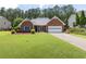 Charming brick home with a well-manicured lawn and an attached two-car garage at 2905 Ivey Ridge Ln, Roswell, GA 30076