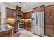 Modern kitchen featuring stainless steel appliances, granite countertops, and dark wood cabinetry at 2905 Ivey Ridge Ln, Roswell, GA 30076