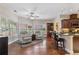 Inviting sitting area with hardwood floors, bright windows, and a breakfast bar to the kitchen at 2905 Ivey Ridge Ln, Roswell, GA 30076