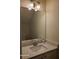 Bathroom featuring a vanity with a wide mirror, white marble countertops and white cabinetry below at 303 Tara Commons Cir, Loganville, GA 30052