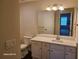 Bathroom features white cabinets, granite counters and large mirror at 303 Tara Commons Cir, Loganville, GA 30052