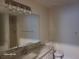 Bathroom featuring decorative light fixture, granite counters and ample vanity storage at 303 Tara Commons Cir, Loganville, GA 30052
