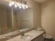 Bathroom featuring decorative light fixture, granite counters and ample vanity storage at 303 Tara Commons Cir, Loganville, GA 30052