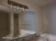Bathroom featuring decorative light fixture, granite counters and ample vanity storage at 303 Tara Commons Cir, Loganville, GA 30052