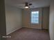 Bedroom features window and ceiling fan at 303 Tara Commons Cir, Loganville, GA 30052