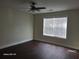 Bright bedroom featuring hard wood floors, a ceiling fan and a large window with blinds at 303 Tara Commons Cir, Loganville, GA 30052