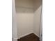 Walk-in closet with built-in shelves and hardwood floors at 303 Tara Commons Cir, Loganville, GA 30052